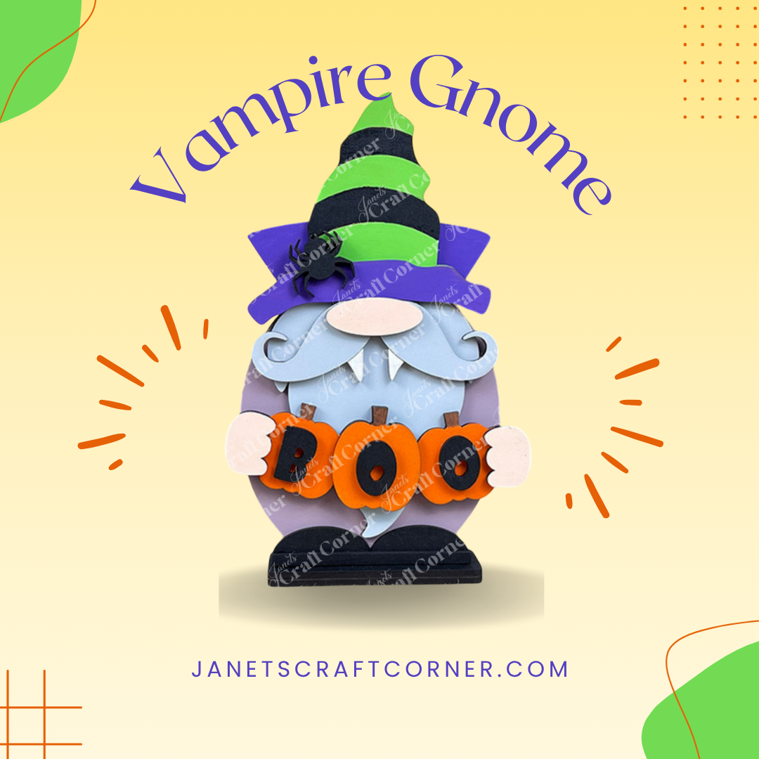 A Vampire Gnome sits with a green and black hat and purple cape, holding orange "BOO" letters. "Vampire Gnome" title above, with "janetscraftcorner.com" below on a light yellow background. Check out our Vampire Gnome Shelf Sitter DIY kit at Janet's Craft Corner for spooky decor!.