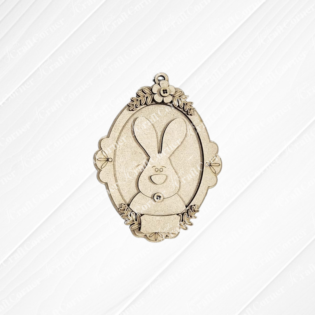 Janet's Craft Corner Framed Easter Bunny Basket Tags: Oval wooden ornaments with a simple bunny face and leaf accents, perfect for personalized Easter décor or as basket tags.