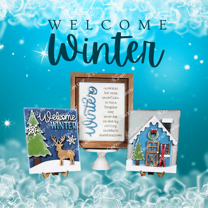 The "Welcome Winter" display from Janet's Craft Corner features a DIY seasonal home decor craft kit. It includes a winter-themed sign with tree and deer motifs and an icy blue background with snowflake designs, ideal for DIY enthusiasts.