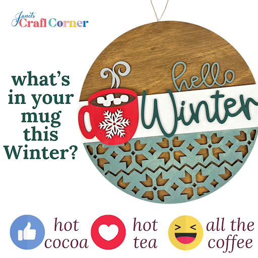 The "Hello Winter Hot Cocoa Wall Hanger" DIY kit from Janet's Craft Corner features a circular wooden ornament with a red mug and snowflake design, asking "What’s in your mug this Winter?" Cozy icons for hot cocoa, tea, and coffee complete this delightful seasonal decor.