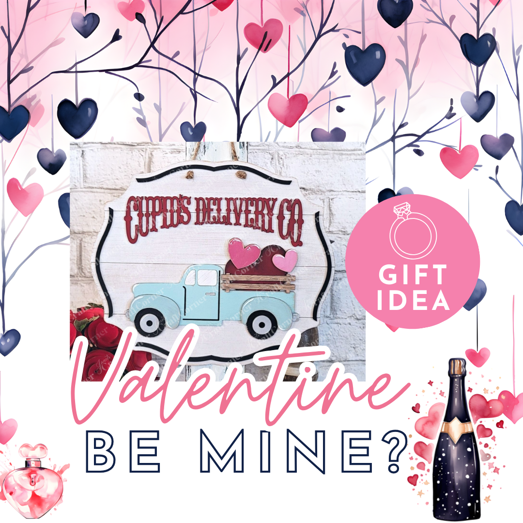 Janet's Craft Corner presents a charming Valentine’s display featuring the Cupid Deliver Co Wall Hanger kit. It includes a rustic sign with a blue truck carrying hearts, surrounded by heart decorations and text "Cupid's Delivery Co" and "Valentine Be Mine?". This easy DIY craft adds hand-painted décor charm.