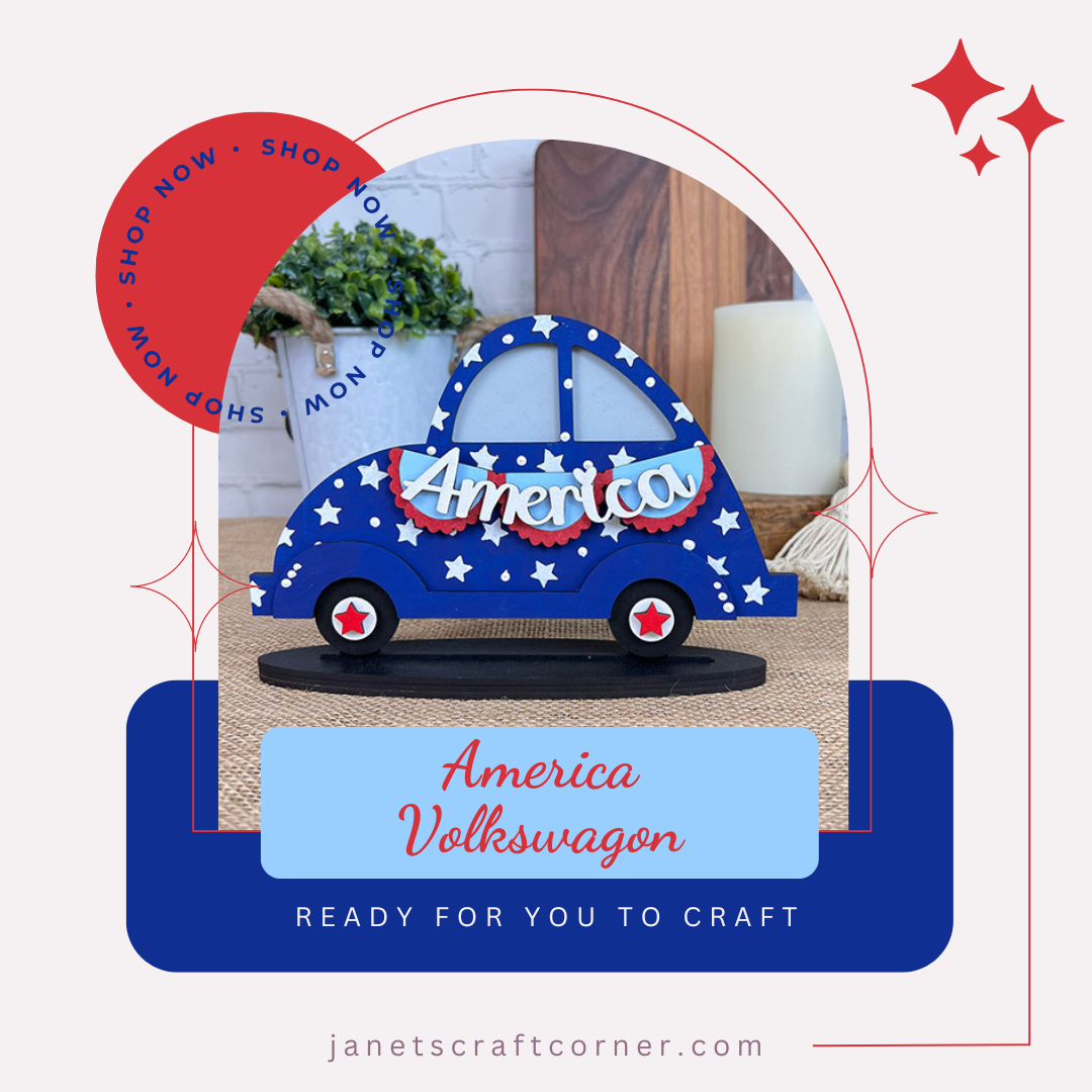 A blue car with white stars reading "America" sits on a table, framed by an arch labeled "America Volkswagen" and "Ready for you to craft." A "Shop Now" badge is noted. Find this Americana figure for your shelf sitter collection at janetscraftcorner.com, courtesy of Janet's Craft Corner.