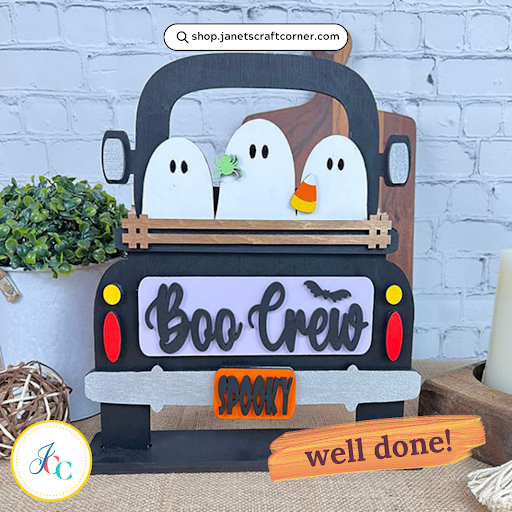 The Boo Crew Interchangeable Insert by Janet's Craft Corner is a DIY decor kit featuring three ghosts in a truck with candy corn, labeled "Boo Crew" and "Spooky." Includes a "well done!" sticker with a plant, making it the perfect festive addition to your Halloween celebrations.