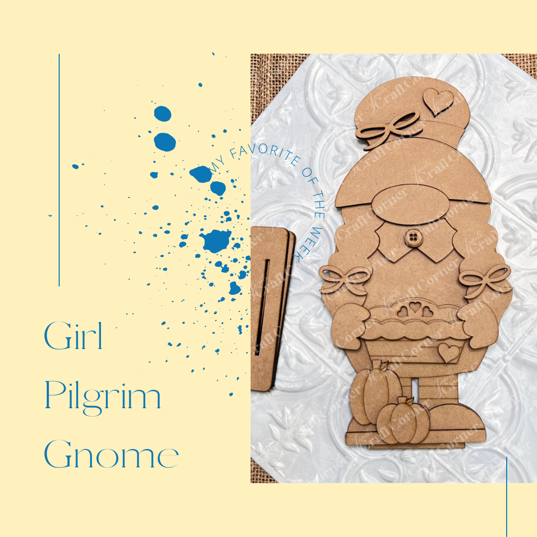 The Girl Pilgrim Gnome Shelf Sitter by Janet's Craft Corner is a charming DIY home decor craft kit featuring a girl pilgrim gnome in a hat and apron, accompanied by smaller cardboard pieces, decorative orange pumpkins, and a subtle floral patterned background with text "Girl Pilgrim Gnome.