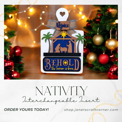 A festive ad for Janet's Craft Corner's Nativity Interchangeable Insert features "Behold, the Savior is born" and "Rejoice" and showcases holiday lights and ornaments. Available at janetscraftcorner.com.