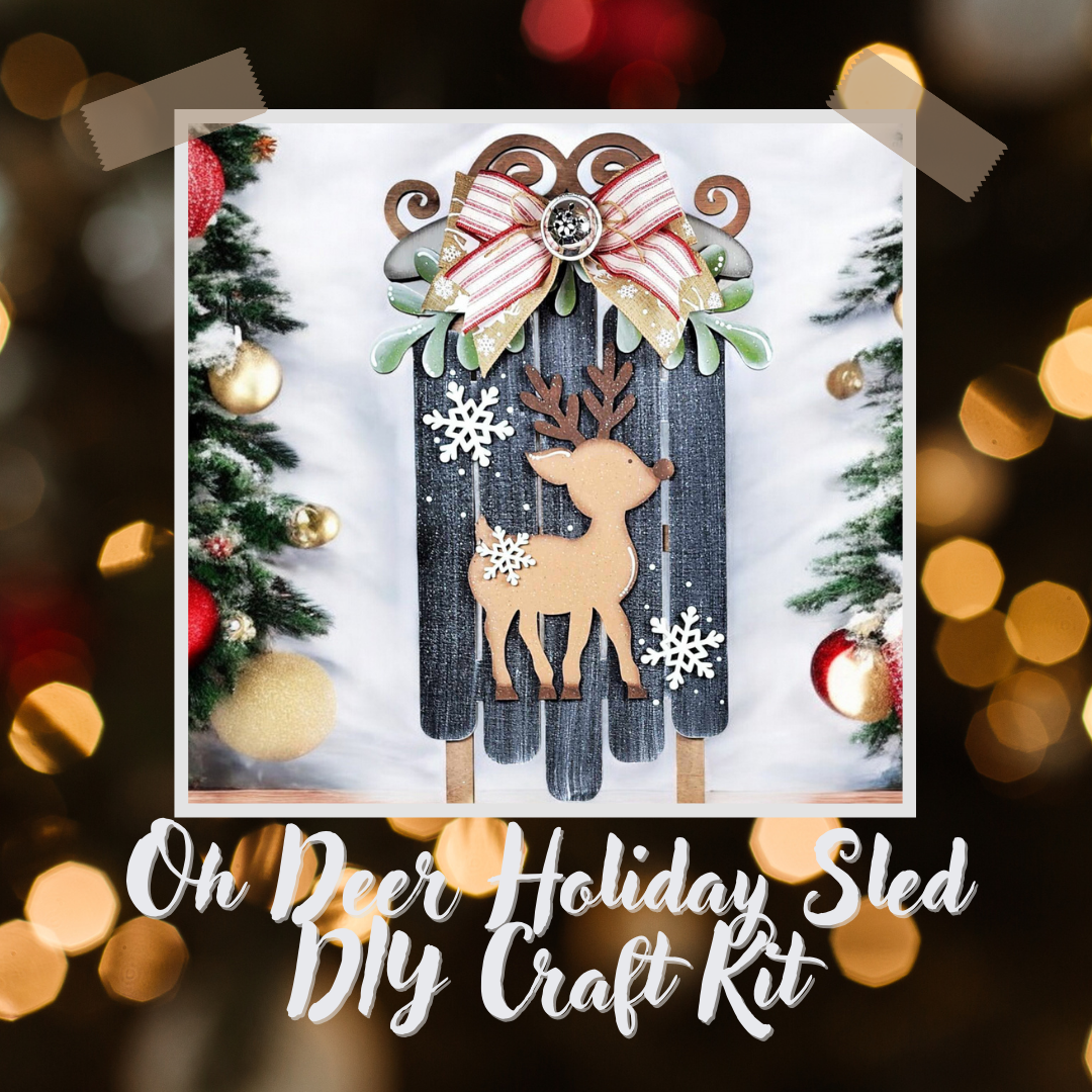 Framed by Christmas trees, ornaments, and blurred lights, the Oh Deer Sled Wall Hanger by Janet's Craft Corner features a festive reindeer silhouette with snowflakes, greenery, and a striped red-white ribbon for charming seasonal decor.