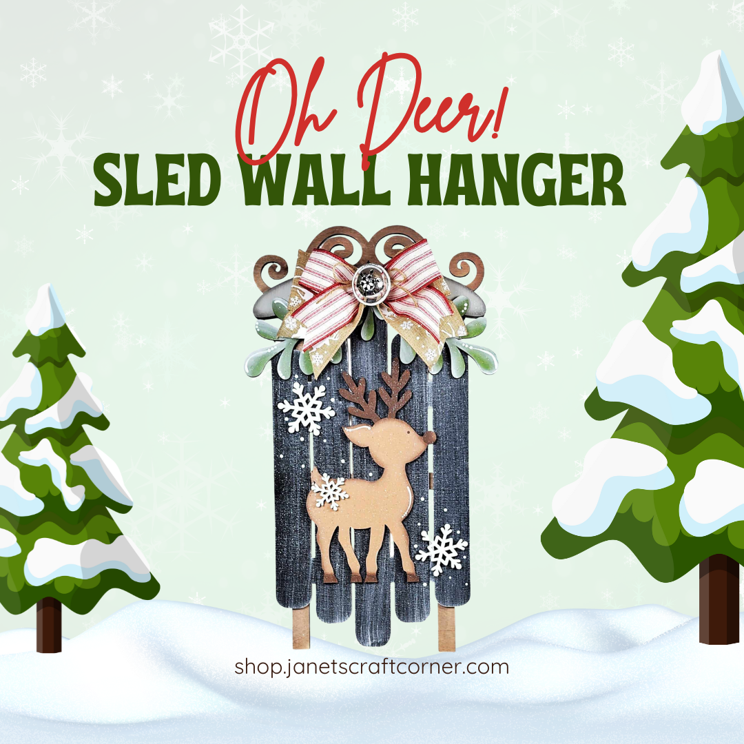 Add holiday magic to your home with the "Oh Deer Sled Wall Hanger" from Janet's Craft Corner. This DIY kit, featuring a reindeer and snowflakes against snowy, tree-decorated backdrops, is perfect for festive decor. Visit shop.janetscraftcorner.com to get your set of 1 today!.