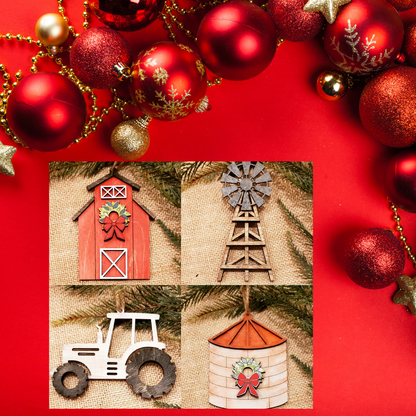 A set of four farm-themed ornaments: a red barn, windmill, white tractor, and silo adorn this DIY decor kit from Janet's Craft Corner. Set against a red backdrop with red and gold beads, it embodies the festive spirit of Farm Life Christmas Ornaments for the holiday season.