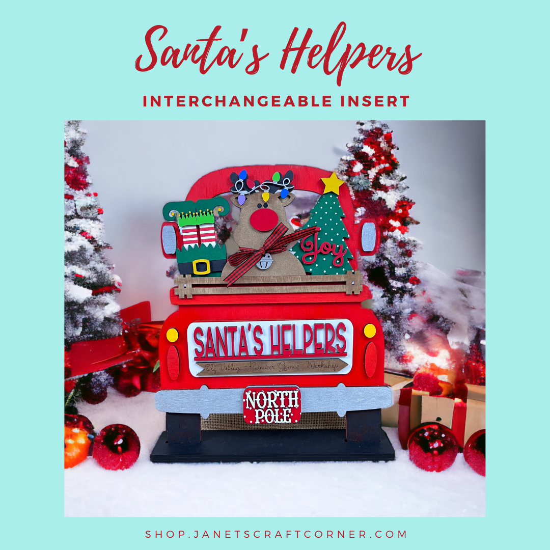 Janet's Craft Corner presents the "Santa's Helpers Interchangeable Insert," a DIY craft kit featuring a festive red truck with decorations among snowy trees, ornaments, and presents. Ideal for home decor lovers seeking a personalized touch. Set of 1.