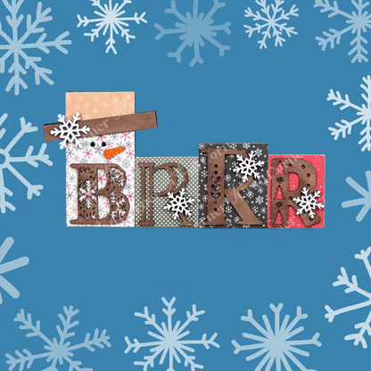 The Brrr Word Block Shelf Sitter by Janet's Craft Corner features "BRRR" with unique patterns in each letter, surrounded by white snowflakes on a blue background, perfect for personalizing your home decor.