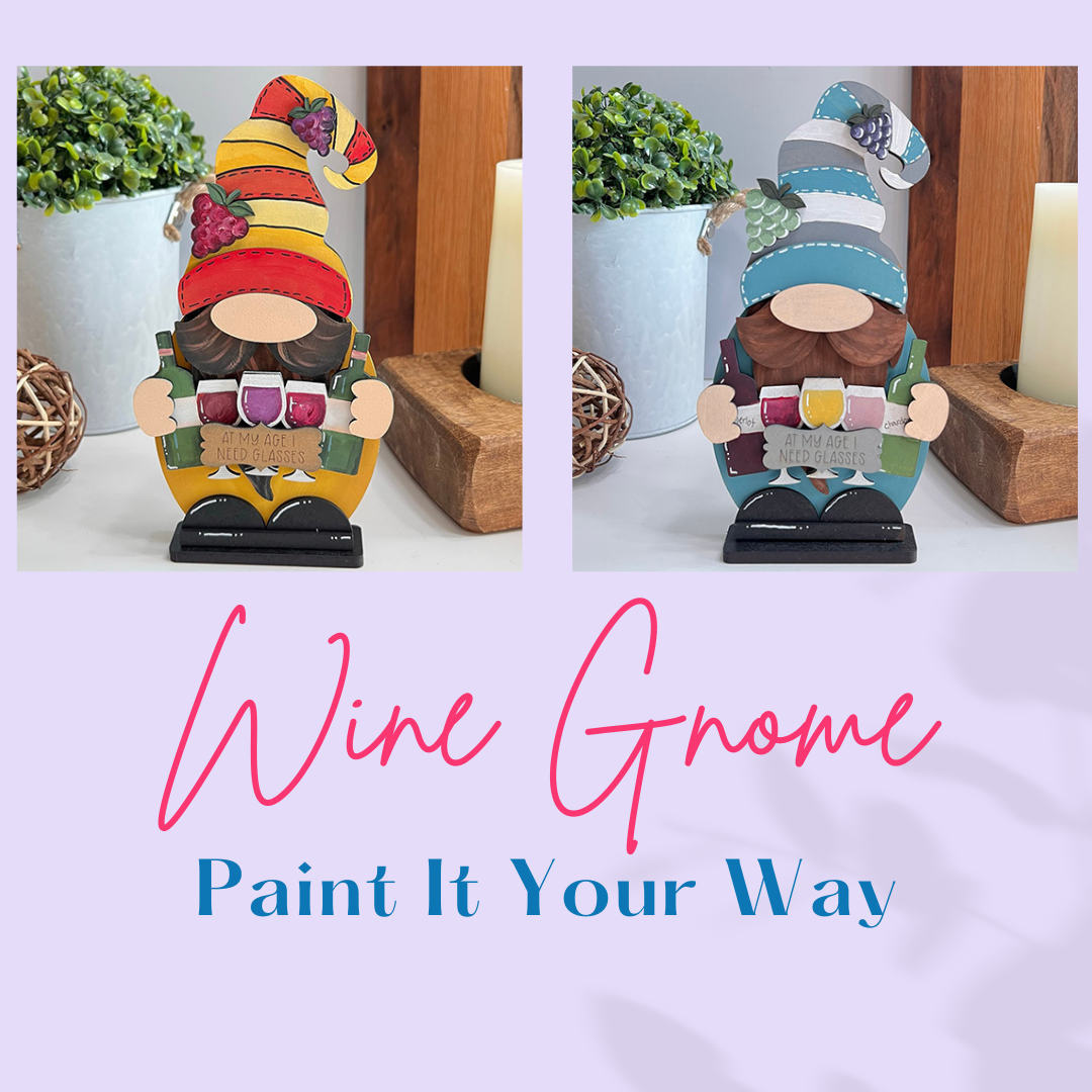 The Wine Lover Gnome Shelf Sitter from Janet's Craft Corner is shown in two painted styles, holding wine glasses against a wooden and plant backdrop. The text reads, "Wine Gnome Paint It Your Way," making it an ideal DIY Kit to enhance your home décor.