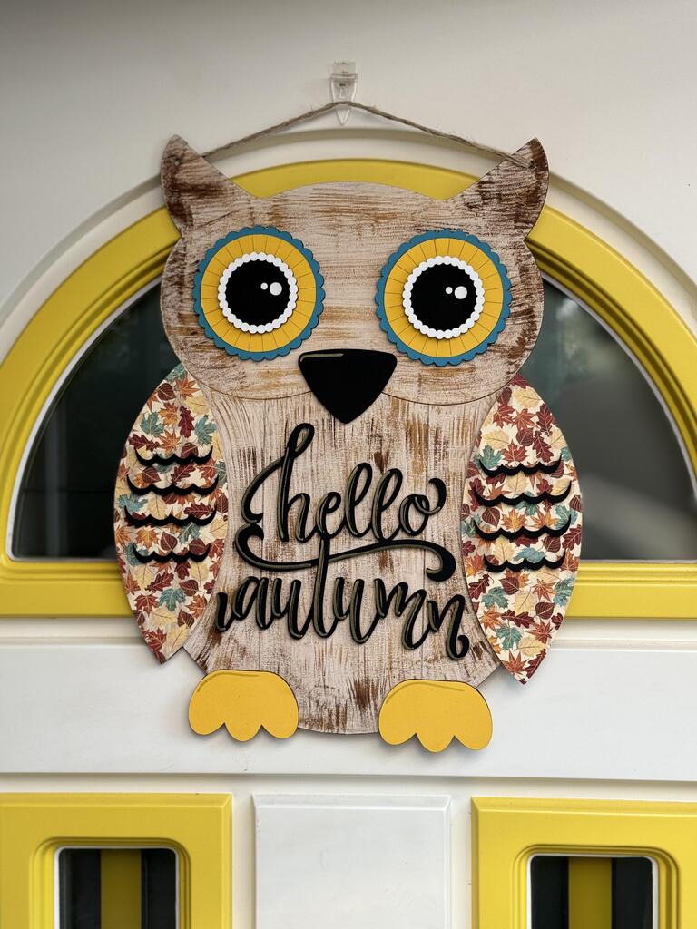 This hand-painted Shiplap Owl Door Hanger from Janet's Craft Corner features colorful wings, big yellow eyes, and a "Hello Autumn" message. Perfectly fits in a door with a half-circle window and yellow trim for welcoming seasonal décor.