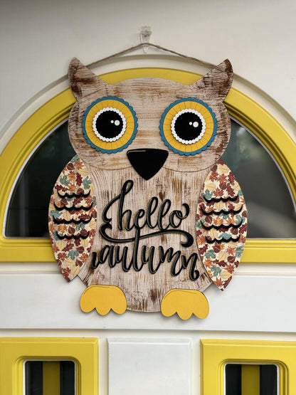 This hand-painted Shiplap Owl Door Hanger from Janet's Craft Corner features colorful wings, big yellow eyes, and a "Hello Autumn" message. Perfectly fits in a door with a half-circle window and yellow trim for welcoming seasonal décor.