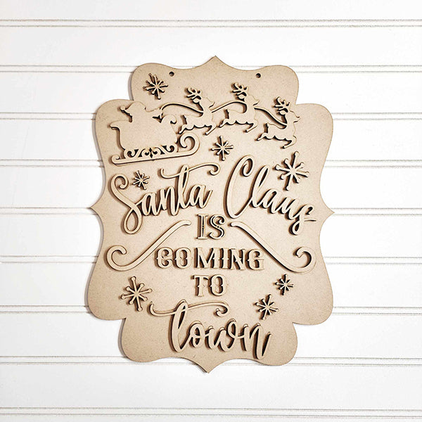 Add holiday charm with the "Santa Claus is Coming to Town Wall Hanger" by Janet's Craft Corner. This festive decor features wooden silhouettes of Santa's sleigh and reindeer atop cursive text, accented with snowflakes. Ideal as a santa door hanger from this DIY seasonal decor craft kit.