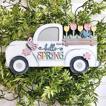 The "Hello Spring" Truck Sign from Janet's Craft Corner features a charming vintage white truck overflowing with vibrant tulips and a small bird. Accentuated with flowers, a butterfly, and surrounded by lush green foliage, this piece beautifully enhances your spring home decor.