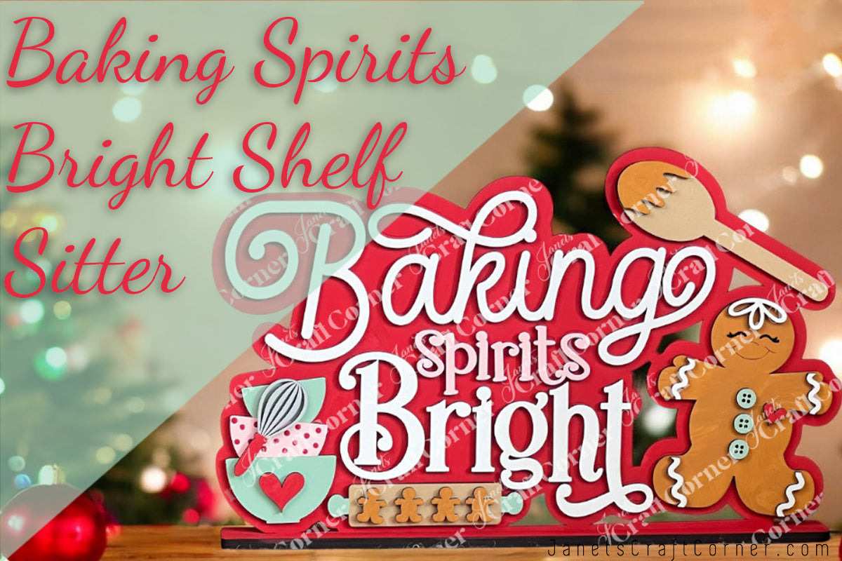 The Baking Spirits Bright Shelf Sitter by Janet's Craft Corner is a DIY seasonal home decor craft kit featuring "Baking Spirits Bright" in decorative fonts with hand-painted cupcakes, cookies, a wooden spoon, and a gingerbread figure against holiday lights.