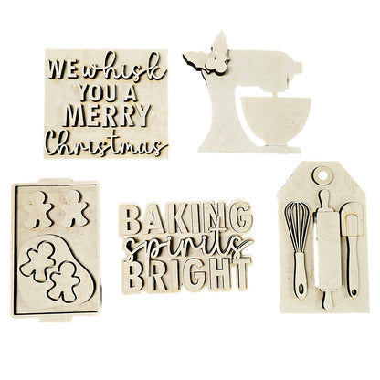 Introducing the **Baking Spirits Bright Decor Set** by *Janet's Craft Corner*! This 5-piece DIY home decor kit features delightful wooden Christmas-themed cutouts, including "We whisk you a Merry Christmas," a stand mixer adorned with holly, and the charming phrase "Baking Spirits Bright." Add festive cheer to your décor with a baking tray of gingerbread figures and a tag showcasing a whisk and spatula.