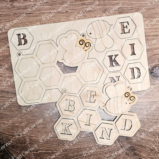 The Be Kind Kids Pop-Out by Janet's Craft Corner includes a charming puzzle with honeycomb-shaped wood cut-outs and bee designs, spelling "BE KIND." Ideal for creative kids who love DIY projects.