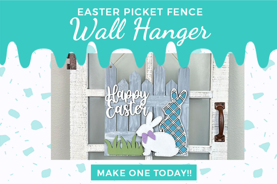 The Easter Picket Fence Door Hanger by Janet's Craft Corner is a rustic, decorative kit featuring a "Happy Easter" sign, white rabbit, plaid-patterned bunny silhouette on a teal backdrop with paint drips and a "Make One Today!!" banner. Perfect for seasonal home décor.