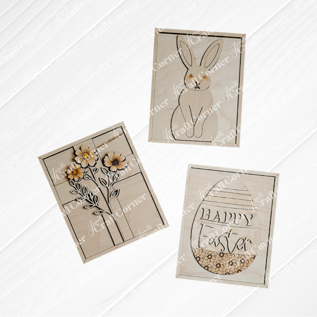 Three greeting cards featuring a rabbit, flowers, and an egg shape with "Happy Easter" text have minimalist designs in neutral tones. These white-background cards pair beautifully with Janet's Craft Corner's Easter Bunny Farmhouse Sign for seasonal home decor.