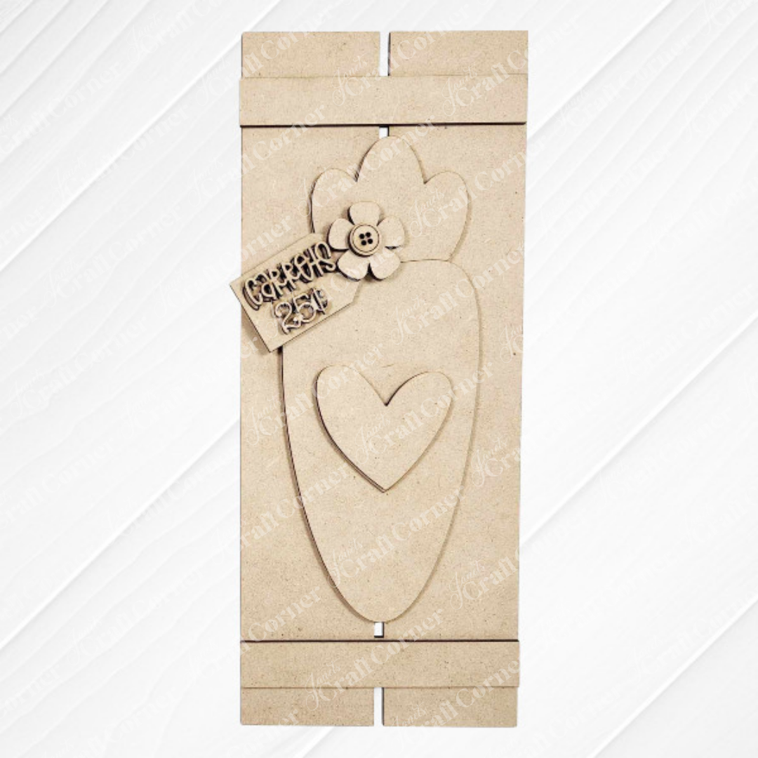 The Carrot Table Top Pallet from Janet's Craft Corner is a charming wooden plaque with a heart cutout and flower at the top. Featuring "CARROT" and "25c" on a small sign, it's ideal for seasonal decor and DIY craft kit lovers on any textured white surface.