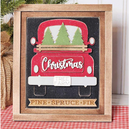 Add a festive crafted touch to your home with the Christmas Truck Interchangeable Sign by Janet's Craft Corner. This DIY craft kit features a hand-painted red Christmas truck carrying green trees. The truck is adorned with a "Christmas Tree Farm" sign, and below it, on a wooden plank, are the words "Pine," "Spruce," and "Fir," all set against a sparkling black background—perfect for your seasonal DIY home decor projects!