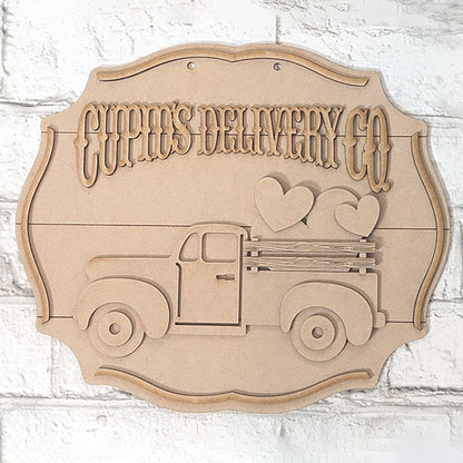 The "Cupid Deliver Co" wooden craft sign by Janet's Craft Corner showcases a vintage truck adorned with three heart shapes, creating an ideal home décor piece for crafters. This charming sign stands out beautifully against a light brick background, adding a lovely touch to any space.