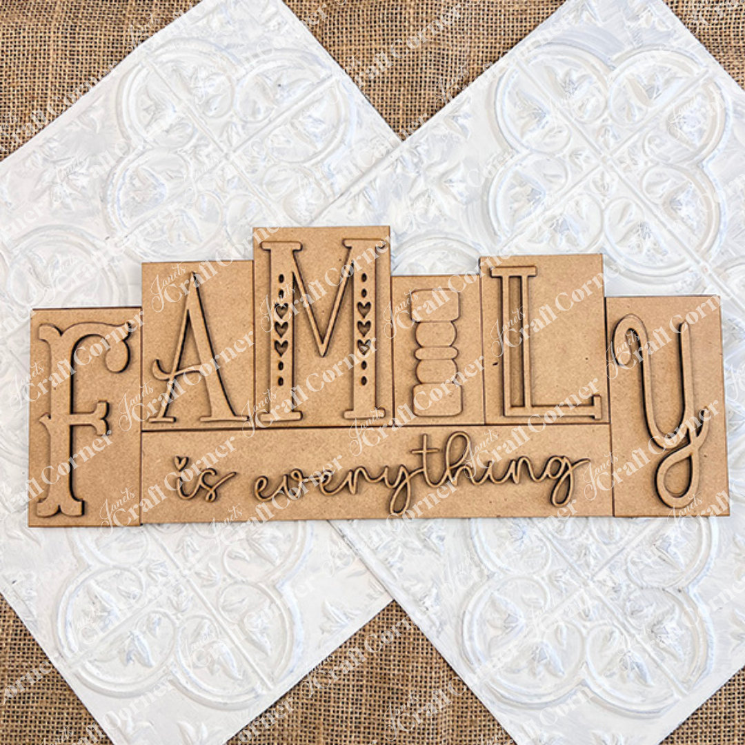 The Family is Everything Word Block by Janet's Craft Corner features "FAMILY is everything" in artistic lettering against a textured beige and white background with intricate patterns, making it ideal for home decor.