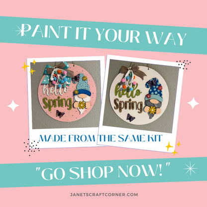 The Hello Spring Gnome Door Hanger from Janet's Craft Corner showcases a DIY seasonal décor craft kit with "Hello Spring" designs featuring flowers, mushrooms, and butterflies. The phrase "Paint it Your Way" appears above, while the bottom text invites you to shop now.