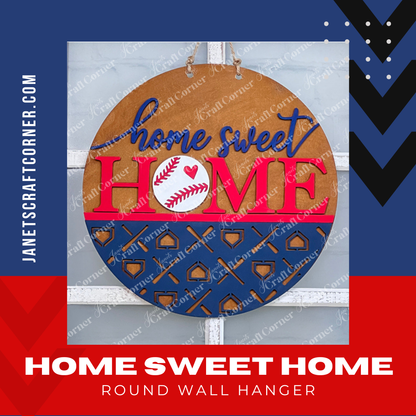 Crafted by Janet's Craft Corner, the Baseball Home Sweet Home Round is a round wooden door hanger featuring "home sweet HOME" emblazoned in blue and red. The "O" in "HOME" is cleverly designed as a baseball with a red heart, accented by a striking blue pattern. This delightful piece is shown with a red and blue graphic with the product title and website.