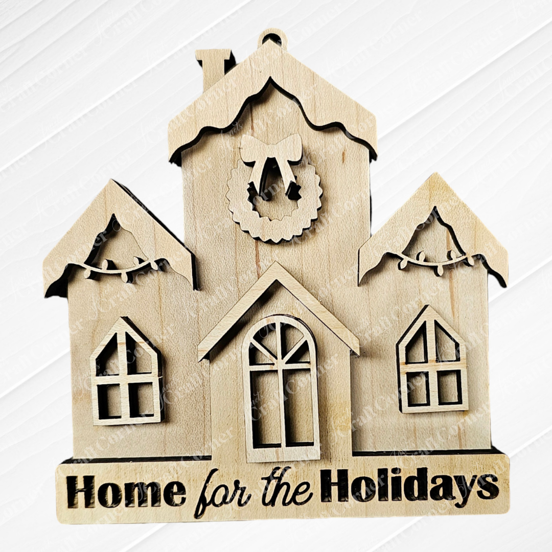 A hand-painted wooden wall decoration from Janet's Craft Corner features a delightful house with three gabled roofs, each beautifully adorned with garlands or a wreath. The phrase "Home for the Holidays" is elegantly carved at the base, making it an ideal addition to your Holiday Village Ornament Set - Early Access.