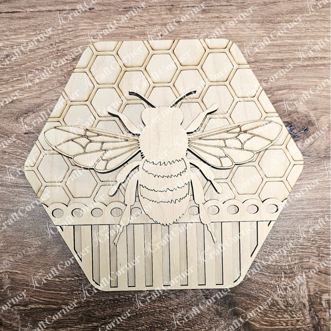 The Honeycomb Shaped Bee Sign by Janet's Craft Corner is a wooden coaster with an engraved bee design at the center, surrounded by intricate honeycomb patterns. Ideal for DIY craft projects, the natural wood grain enhances its charm.