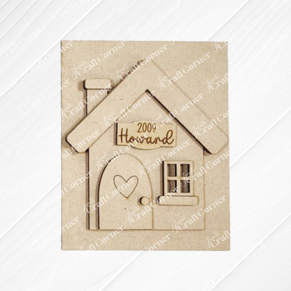 Janet's Craft Corner offers a House Interchable Farmhouse Sign, a DIY home decor craft kit with engraved details. Personalize it with "Howard" and "2009," featuring a heart-adorned door and window on a textured white background, perfect for home decor enthusiasts.