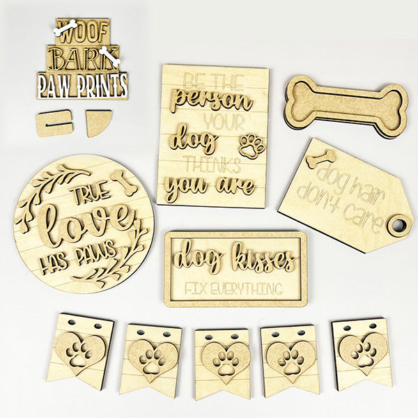 The Dog Lover Decor Set by Janet's Craft Corner is a DIY home decor craft kit featuring 7 wooden plaques and tags with dog-themed phrases like "Be the person your dog thinks you are" and "Dog hair don't care," plus paw print designs, perfect for celebrating that true love has paws.