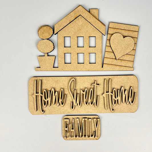 The "Home Sweet Home Interchangeable Insert" DIY home decor kit from Janet's Craft Corner adds a personalized touch to your space with wooden cutouts, including a house with a potted plant, a board with a heart, and the words "Home Sweet Home" and "Family." It's perfect for interchangeable home decor suited for any season or occasion.