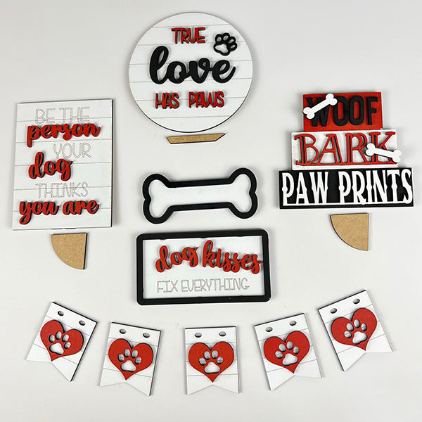 Introducing the Dog Lover Tiered Tray Kit by Janet's Craft Corner, a delightful assortment of decor for dog enthusiasts. This kit includes charming signs and decorations with phrases like "True love has paws," "Woof bark paw prints," "Be the person your dog thinks you are," and "Dog kisses fix everything." Adorned with paw print and bone designs, it's the perfect addition to any DIY home decor project.