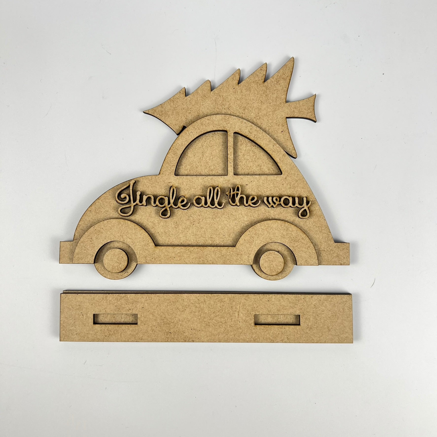 Janet's Craft Corner presents the "Jingle All the Way" Volkswagen Shelf Sitter, a wooden car cutout with an evergreen tree on top. It features engraved words and includes a rectangular base with two slits for easy assembly, perfect for adding yuletide cheer to your home.