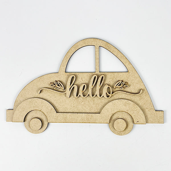 The Hello Volkswagen DIY kit by Janet's Craft Corner includes an unfinished wooden cutout shaped like a vintage car with "hello" in the center, leaf designs, two windows, and two wheels. This farmhouse-style decor craft is perfect for enhancing any home.