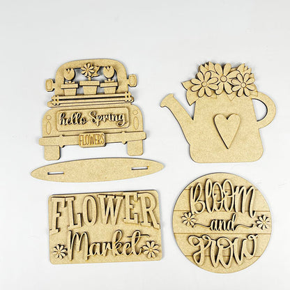 Janet's Craft Corner offers a Flower Market Mini Shelf Sitters set, featuring wooden cutouts of a truck with potted plants labeled "hello Spring," a watering can with flowers, and signs that read "Flower Market" and "Bloom and Grow," perfect for your DIY spring tiered tray decor.