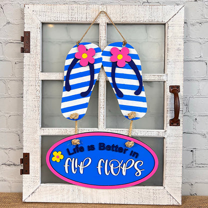 This delightful Flip Flops Door Hanger from Janet's Craft Corner is perfect for decorating a white rustic window. The sign features charming blue and white striped flip-flops adorned with pink flowers, along with the inspiring message "Life is Better in Flip Flops" on a blue oval accented with a pink border—an enchanting addition to any home décor.