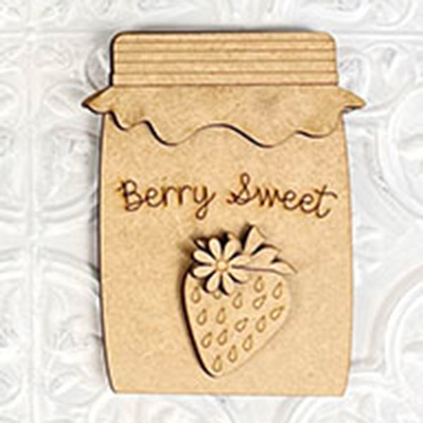 The Strawberry Mini Shelf Sitters from Janet's Craft Corner boast a charming design with their jam jar shape and "Berry Sweet" engraving. Featuring a carved strawberry and flower, it is set against a textured white background, making it an ideal addition to infuse farmhouse chic into your decor.