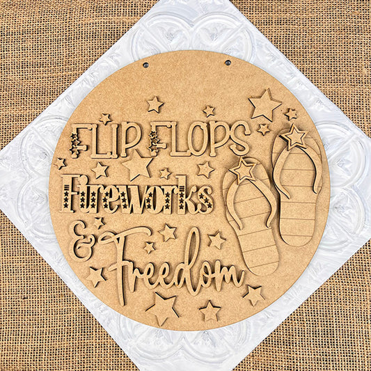 Janet's Craft Corner presents the Patriotic Flip Flops Door Hanger, showcasing a round wooden sign with "Flip Flops Fireworks & Freedom" surrounded by stars and flip flops. Set against a burlap background, it captures the spirit of summer celebrations.