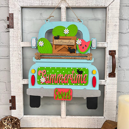 This delightful piece from Janet's Craft Corner, the Summertime Watermelon Interchangeable Insert - Painted, showcases a decorative wall hanging with a vintage truck brimming with watermelons and a "Summertime Sweet" sign. The hand-painted ornaments add charm as the truck is mounted on a rustic whitewashed wooden frame, decorated with tiny ant figurines on the watermelons.