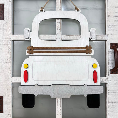 The Antique Truck Interchangeable Base - Painted from Janet's Craft Corner is a wooden décor piece shaped like an antique truck, featuring wood cut-outs for red and yellow tail lights and a brown slat across the rear.