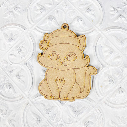 Janet's Craft Corner presents the Color Your Own Ornament, part of their DIY Decoration Kits, featuring an adorable wooden ornament of a cute cat in a winter hat set against an embossed floral background. It includes a convenient hook at the top for easy hanging, making it ideal for customizing your home décor projects.