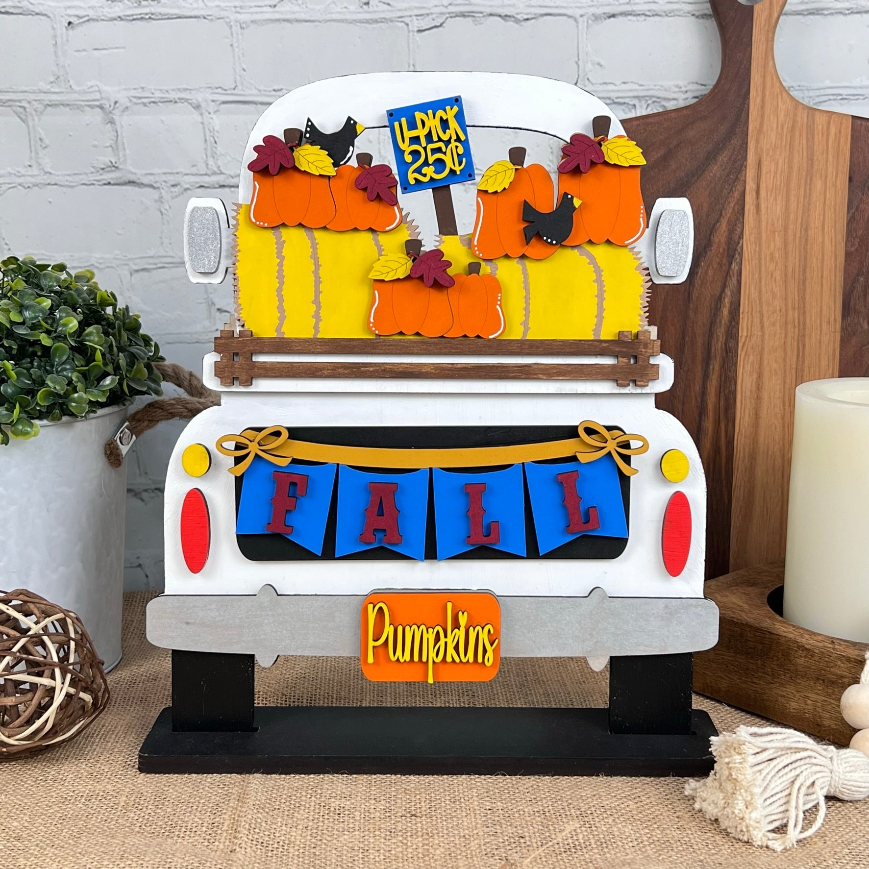 The Antique Truck Base with Insert by Janet's Craft Corner features a rustic truck adorned with colorful pumpkins, a "FALL" banner, and "Pumpkins" and "Pick of the Patch" signs, perfect for DIY home décor lovers.