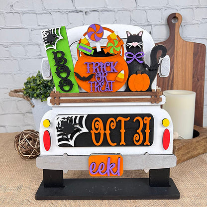 An enchanting Halloween-themed display depicts the rear of a truck adorned with vibrant signs that say "Boo," "Trick or Treat," and "Oct 31." This DIY craft kit from Janet's Craft Corner, named the Oct 31 Interchangeable Insert, features hand-painted elements including candies, a black cat with a pumpkin, and other festive decorations—ideal for creating versatile home decor.