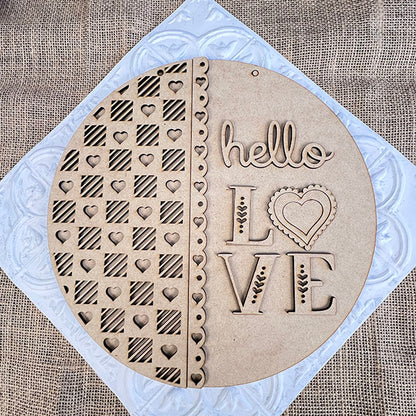 The Hello Love Round Sign from Janet's Craft Corner is a laser-cut wooden decoration featuring hearts, stripes, and "hello LOVE," with a heart for the "O." Ideal as home decor or part of your DIY kit, it adds charm to any space.