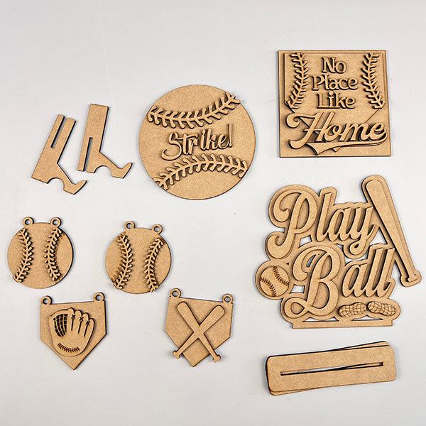 Baseball Decor Set by Janet's Craft Corner: A 6-piece DIY seasonal home decor craft kit with wooden baseball-themed cutouts, featuring "Strike" ball, "No Place Like Home" sign, "Play Ball" with bats and balls, a glove, crossed bats, and a flat base piece. Perfect for DIY enthusiasts.