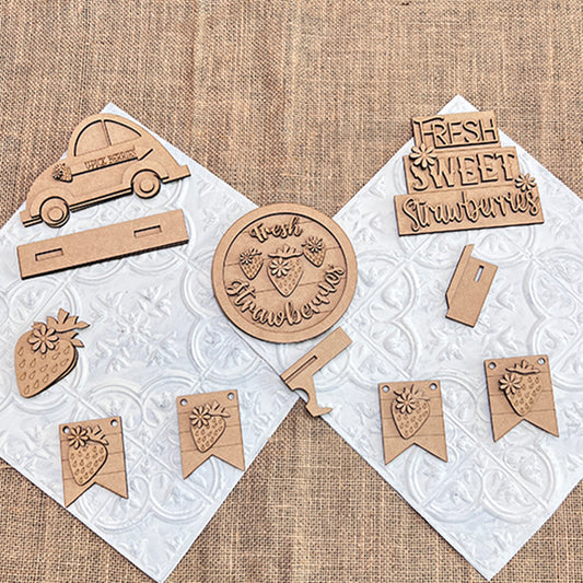 Janet's Craft Corner offers the Strawberry Decor Set, a DIY seasonal home decor craft kit featuring laser-cut wooden crafts. The six-piece set includes a car, circle ornaments, banners, and charming signs like one reading "Fresh Sweet Strawberries," ideal for DIY enthusiasts.